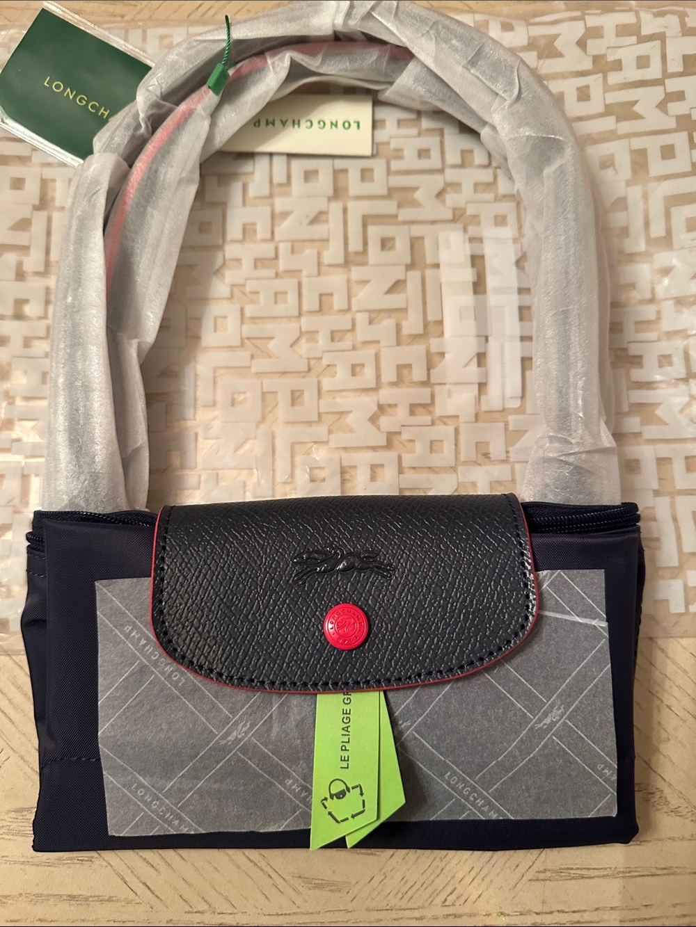 Stylish navy mini bag with black flap and red trim
